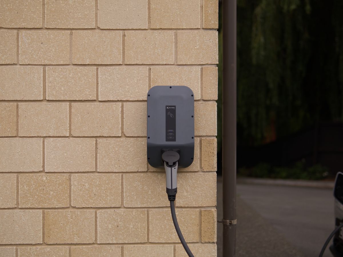 Wall-mounted Level 2 EV charger professionally installed on an Arcwell residential job